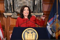 New York Gov. Kathy Hochul presenting her 2026 executive state budget at a podium in the Red Room at the state Capitol in Albany, N.Y.