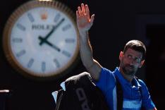 Novak Djokovic waves to the crowd after withdrawing from his Australian Open semifinal match with Alexander Zverev because of injury.