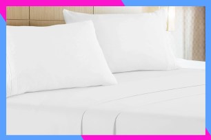 A bed with white sheets and pillows